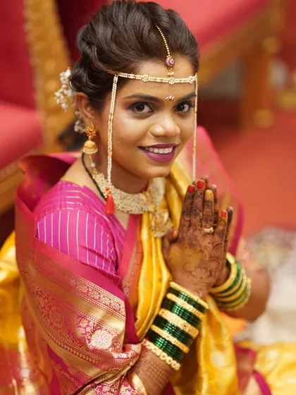 A traditional Maharashtrian bride during her Haldi ceremony. Her makeup is subtle and classic, letting her natural beauty and the traditions shine.