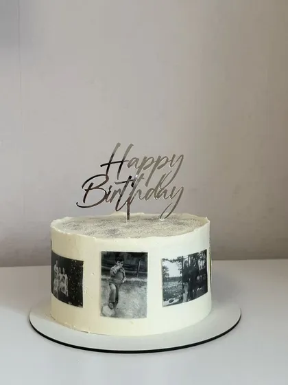 A classic "Happy Birthday" with a personal twist. This design features a clean white frosting that makes the black and white photo reel pop. Topped with an elegant silver script, this memory cake is a beautiful and simple way to honor someone special on their day.
