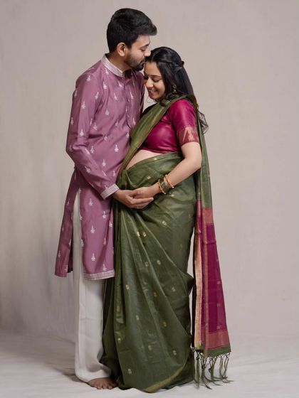 A tender forehead kiss, a classic expression of love and protection. This studio portrait, part of their traditional maternity session, is all about capturing the deep emotional bond between the parents-to-be.
