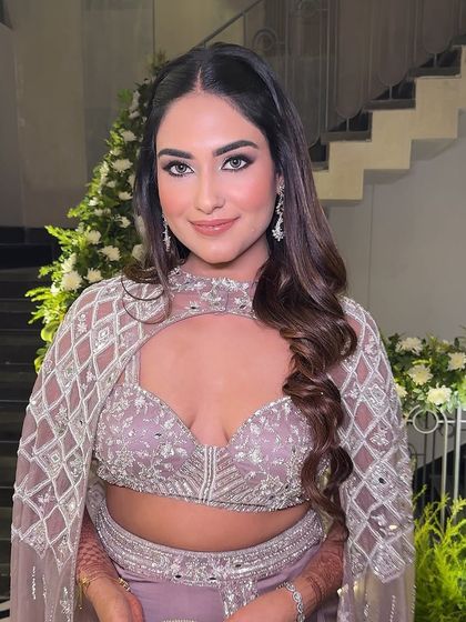 A beautiful portrait shot. Her eyes are the star of the show, with a dramatic smokey look that is perfect for a festive night.