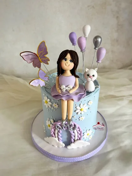 A purr-fect cake for a little girl who adores her pet cat and the color purple. I created a custom sugar figurine of her with her beloved kitten.