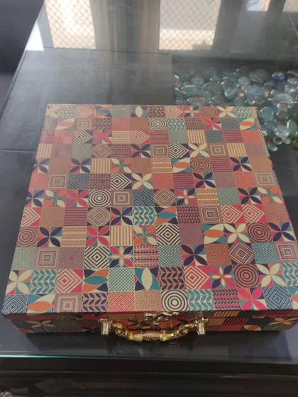 This is the exterior of a custom wedding box I created for my brother's wedding. The vibrant, multi-patterned trunk box with a sturdy handle was designed to be both beautiful and practical for gifting to relatives.