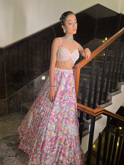 A series showcasing our "soft girl era" lehenga. The printed skirt, pearl-fringed blouse, and sheer embroidered jacket make it a dreamy and feminine choice for a day event.