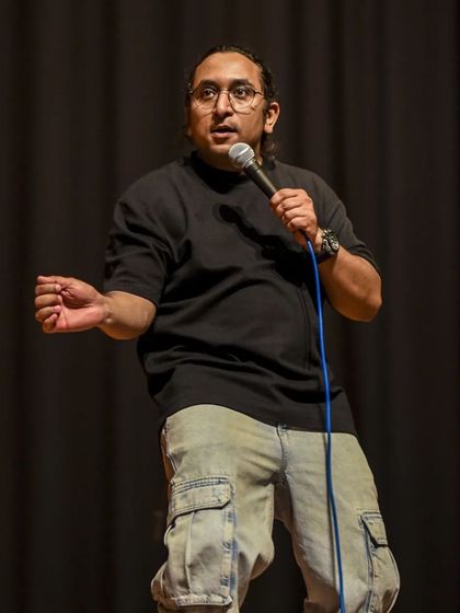 Guptaji's expressive style of comedy captured during his live performance.