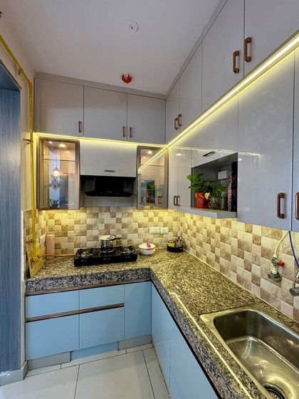 Another shot of the L-shaped kitchen, showing the placement of the sink and the ample counter space available for food preparation.