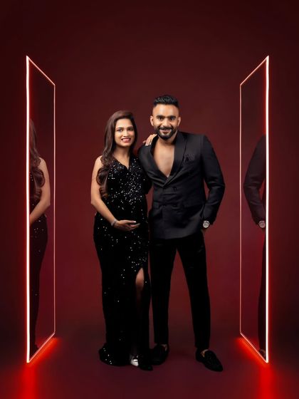 A full-length power pose from a fashionable couple, showcasing a modern and edgy approach to maternity photography.