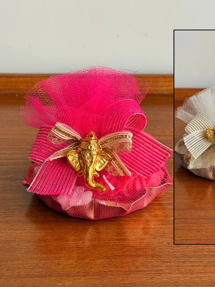 Another version of our festive potli gift, this one in a vibrant pink. These small, thoughtful gifts are ideal for bulk orders and party favors.