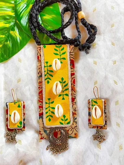 This is another photo of the yellow Kalamkari and cowrie shell necklace, offering a consistent view of this popular design.