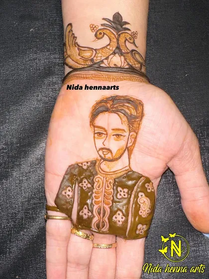 A close-up of a realistic groom portrait on the palm. I pay close attention to details like the style of the turban and the groom's expression.