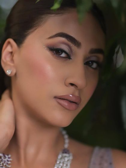 Eyes that captivate, makeup that mesmerizes. This close-up shot showcases a smokey, shimmery eye look that is perfect for a cocktail party or reception.