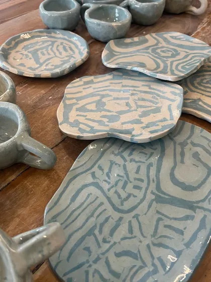 A collection of beautiful plates and cups made using the Japanese Nerikomi technique. Each piece has a unique marbled pattern created by layering colored clays.
