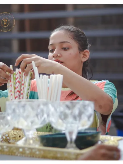 Behind the scenes, one of our team members carefully arranges eco-friendly straws, preparing the bar for a night of crafted cocktails.