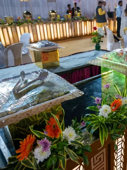 A view of the food trays, neatly covered and arranged on the decorated counters before service begins. I pay attention to details like presentation and hygiene.
