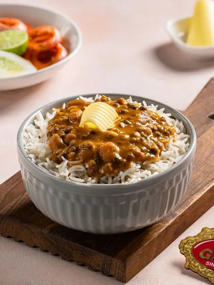 A rich and creamy Dal Makhani served over rice, shot for Gulab Sweets.