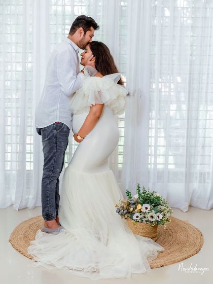A tender forehead kiss, a classic expression of love and care. This intimate moment is beautifully captured in our bright and airy studio.