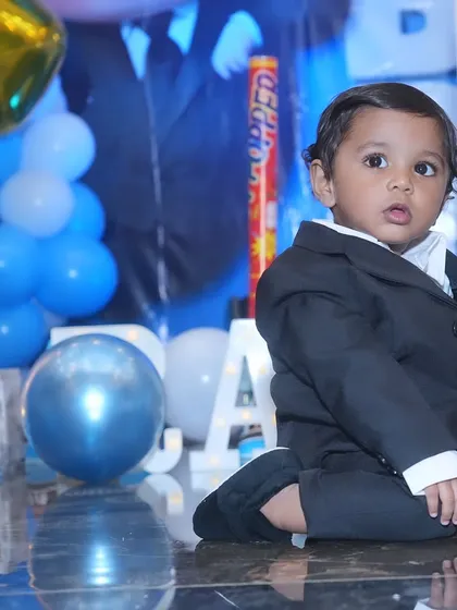 The little 'Boss Baby' looking sharp in his suit at his first birthday party.
