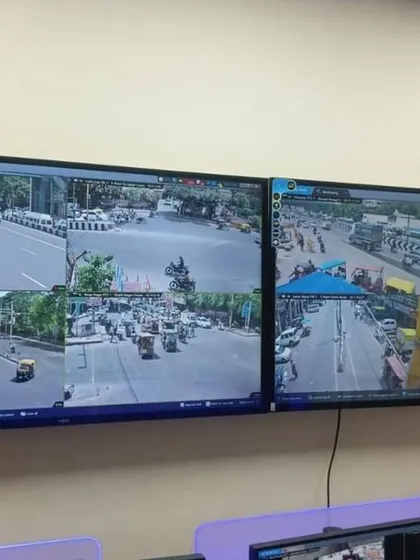 Two large wall-mounted monitors showing multiple camera angles of a busy street. This kind of setup is ideal for businesses or security offices that need to watch over a large area.