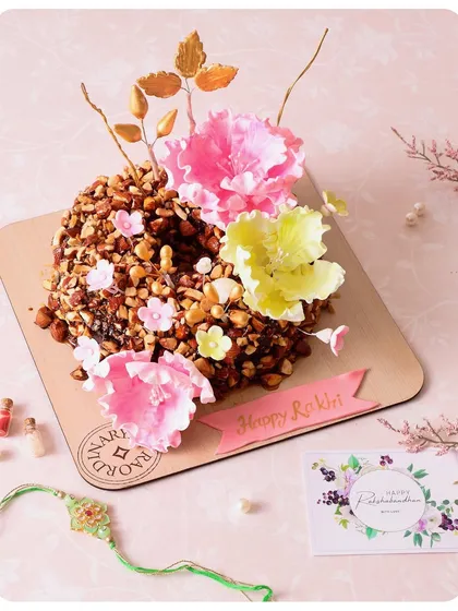 For a more decorative option, our Almond Praline cake is adorned with handcrafted sugar flowers for Rakhi.