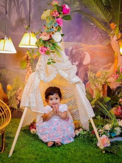 A full view of our enchanted forest teepee setup. This theme includes a lace teepee, a wicker chair, a glowing lamppost, and a lush forest backdrop for a magical camping adventure.