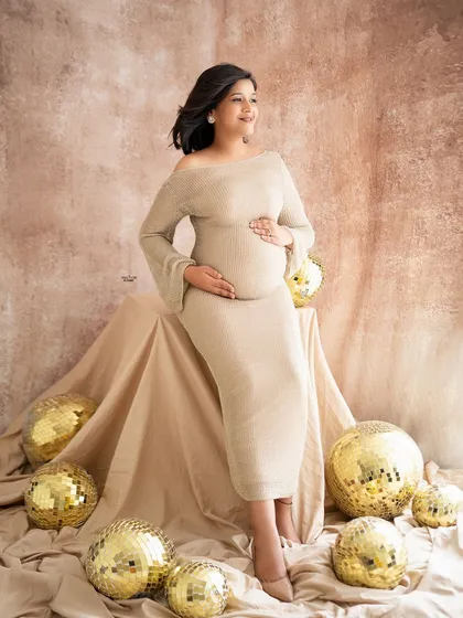 A fun and glamorous shot with golden disco balls. This adds a touch of party-ready sparkle to the neutral, earthy-toned setup.