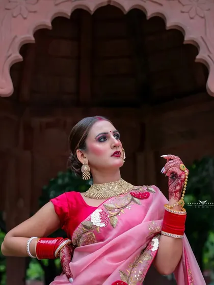 A close-up portrait focusing on the model's strong expression and traditional jewelry.