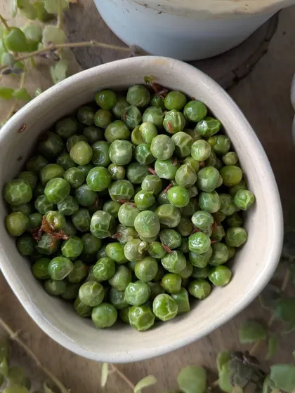 A simple bowl of sautéed green peas. This is a perfect example of a seasonal, simple, and healthy snack that I enjoy during the winter.