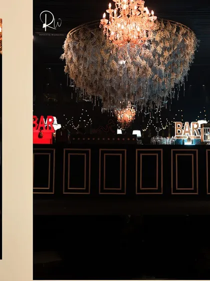 A floral chandelier and a custom bar front, demonstrating how I carry a design theme across different elements of an event.