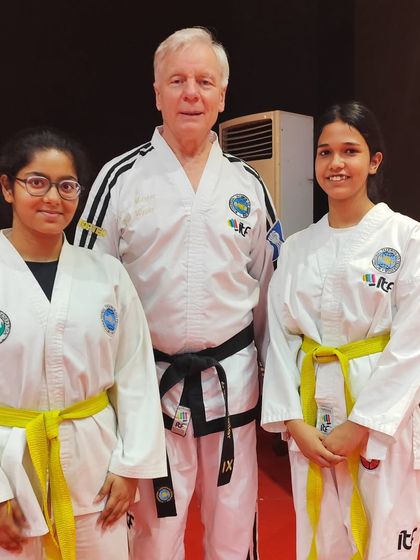 Two of our female students with Grandmaster Weiler, showcasing the opportunities available to all our members.