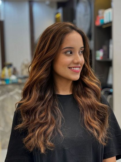 The same beautiful hair color, styled with soft waves to show off the dimension and shine.
