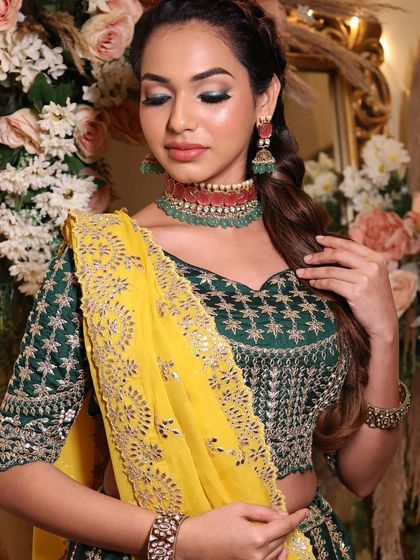 Another angle of this daring and chic look. The green eyeshadow makes her eyes pop and adds a modern flair to the traditional outfit.