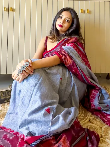 A relaxed, seated pose in the Ikat saree. The cotton fabric is breathable and comfortable, making it a great choice for a long day.
