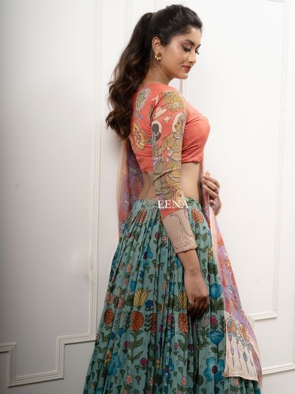 Discover the beauty of traditional craftsmanship with this stunning Pen Kalamkari lehenga. The piece is meticulously hand-painted by my artisans, with a story unfolding on the blouse sleeves and a beautiful floral pattern on the skirt and dupatta.