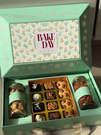 This beautiful floral-themed festive hamper for Diwali contains a mix of my eggless brownie bites, cookies, and two jars of savory nuts.