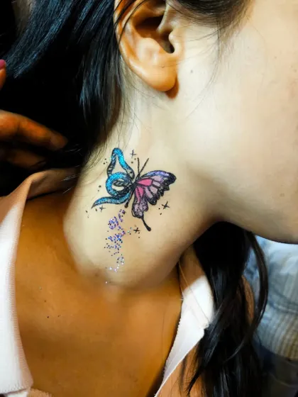 A beautiful butterfly temporary tattoo with a sprinkle of glitter. This kind of face and body art is so much fun for parties and music events.