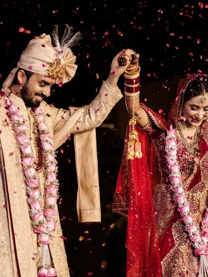 A joyful moment as the couple celebrates their union. The shower of rose petals adds a touch of romance and celebration.