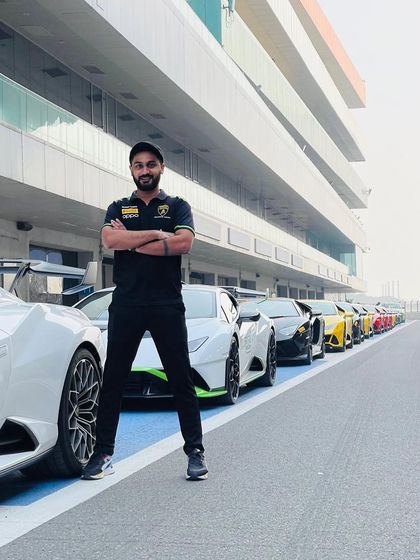 Standing with a fleet of Lamborghinis at the track. My experience extends to dynamic, action-oriented events that require a high-energy, adrenaline-pumping soundtrack.