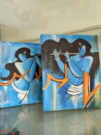 A pair of complementary Krishna paintings, perfect for creating a diptych. These pieces share a similar style and color scheme, capturing the dynamic and enchanting energy of Lord Krishna playing his flute.
