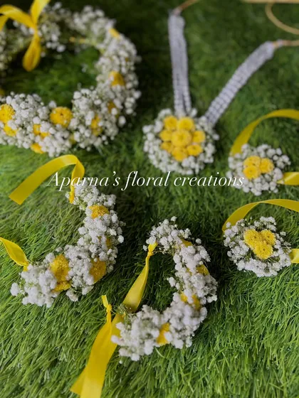 Another view of the yellow and white Haldi set, showing the necklace, earrings, and haath phool.