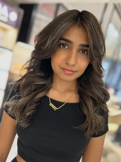 A front view of the cool beige balayage, showing how the color and cut brighten her face and enhance her features.