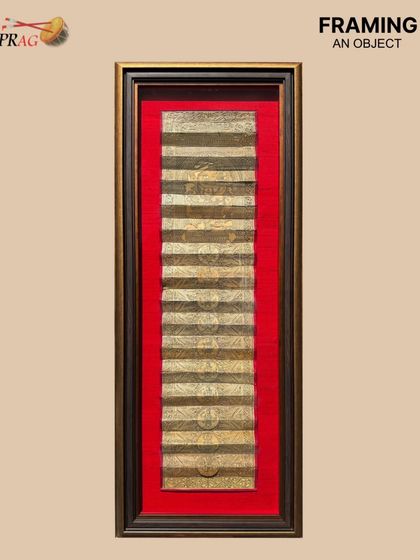 This antique Pattachitra scroll is given new life within a custom frame. The double frame moulding, combining an antique gold box with a two-toned brown and gold outer frame, creates a regal presentation.