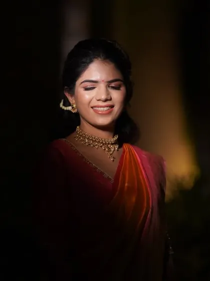A dramatic bridal portrait using creative lighting techniques. The focused light highlights the bride's serene expression and beautiful features during her Haldi function.