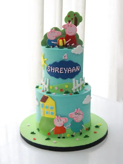 A full view of the Peppa Pig birthday cake, showcasing the happy scene with Peppa, George, and their parents. All the characters and decorations are handmade and completely edible.