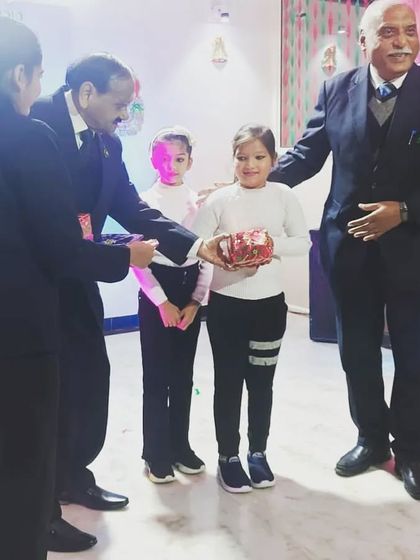 A student receiving a gift during our Christmas celebration. These small moments of joy are very important to us.