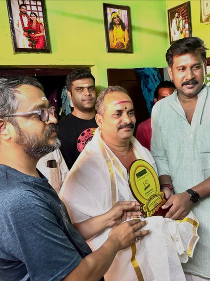 Presenting a memento to our esteemed visiting Guru, Shri Peruvanam Sankaranarayanan Marar, as a mark of our respect.