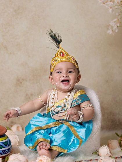 This is a duplicate of image 146. A playful baby Krishna, with a bit of 'butter' on his face, sitting in a chair.