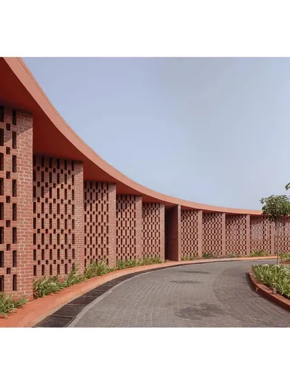 The curved brick jali wall at the Dr. Vishnuvardhan Memorial is a key element of the design. It creates a semi-permeable screen that filters light and air, forming shaded, in-between spaces for people to gather, reflecting my goal to design for community interaction.