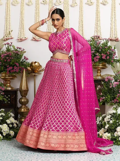 A full-length view of our fuchsia Bandhani lehenga, showcasing its grand silhouette and rich color. This is an outfit designed to make you feel like royalty on your special day.
