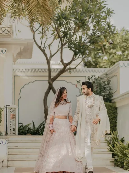 A candid moment of the couple walking hand-in-hand through the palace grounds. My planning ensures you have these quiet moments together, surrounded by the beauty of your chosen destination.