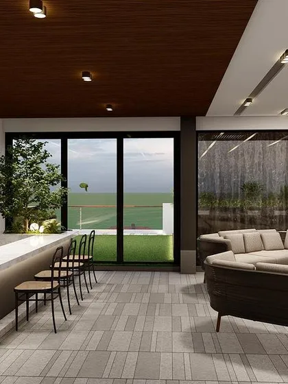 The interior of the Punjabi Bagh terrace project, featuring a lounge and a full bar. The sliding glass doors open completely to merge the indoor space with the outdoor deck.