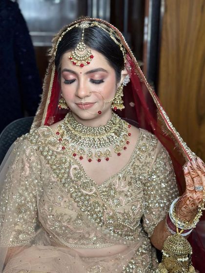 A close-up of bride Nupur, showing the delicate details of her maang tikka and necklace.